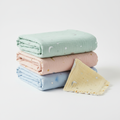 Baby swaddle blanket set in pastel colors with star and moon patterns